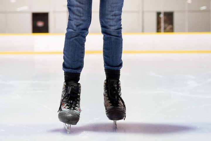 A closeup shot of a female ice skating with a blurred background