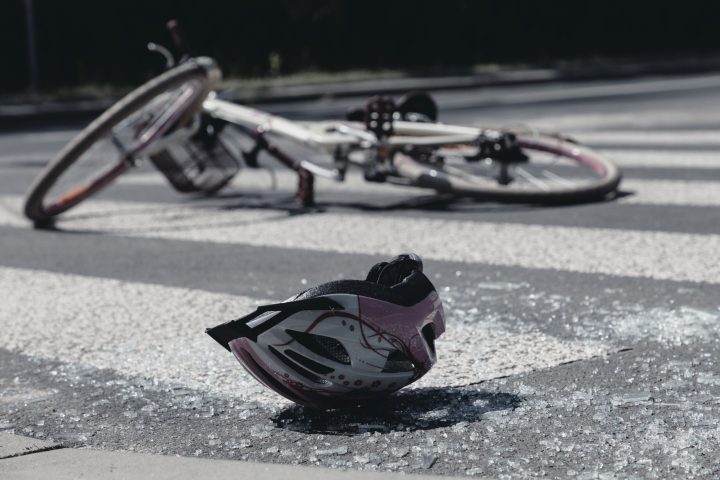 Broken child's helmet and bike on pedestrian crossing after terrible accident