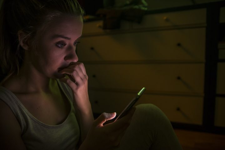 Young woman calling by phone. Emotive face close up girls with a mobile phone