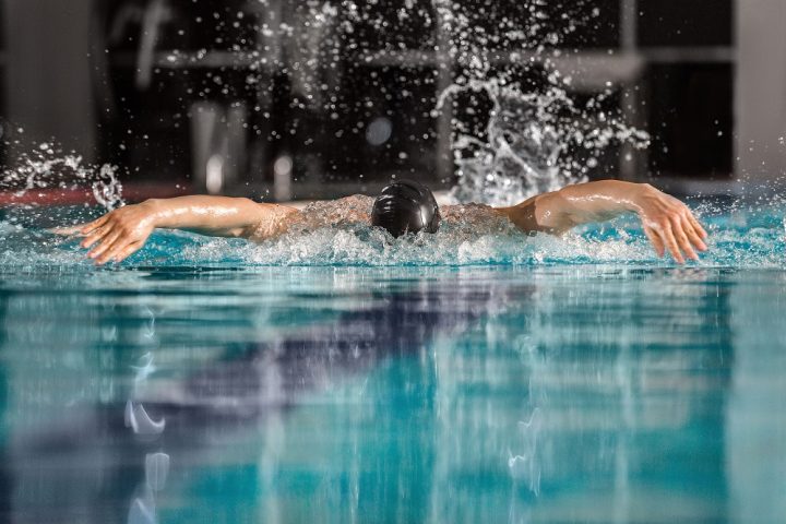 Male swimmer swimming the butterfly stroke in a pool