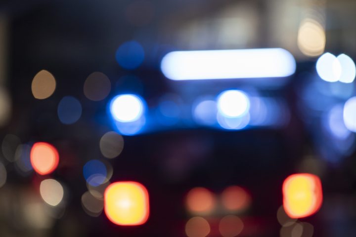 Detail of Blurred emergency background with blue lights in the city at night