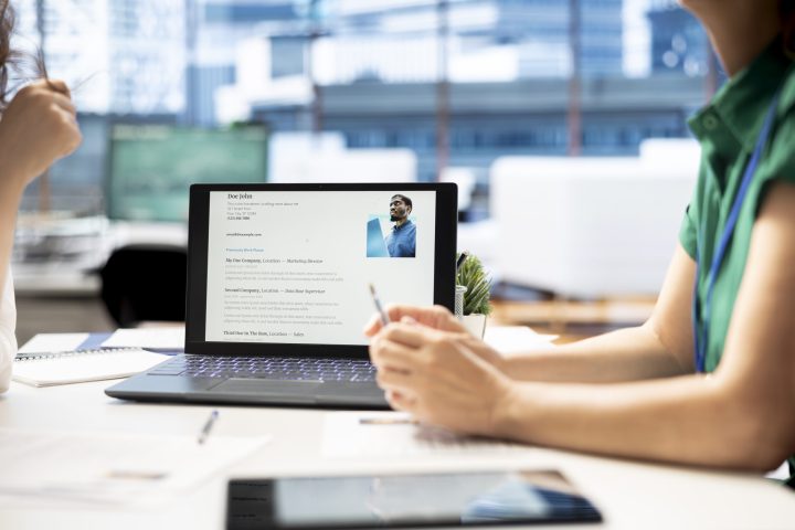 Notebook on office desk used by HR expert vetting applicants to ensure skills match role needs. Close up shot of laptop used by headhunter assessing candidate work experience