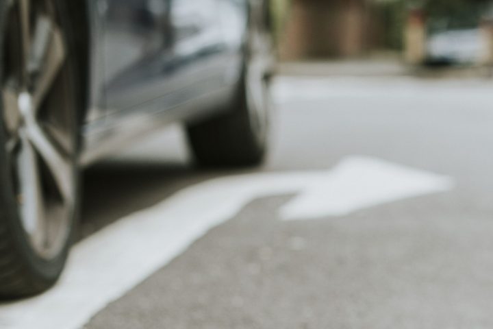 Person lying on the ground after a car accident