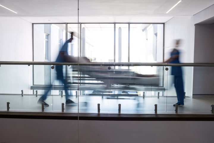 Team of doctors taking pregnant woman to operation theatre in the hospital