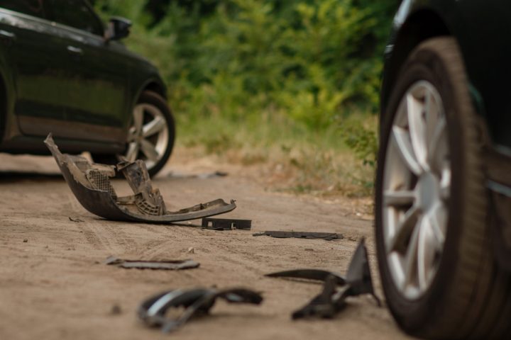 Upset male drivers after car accident on road. Automobile crash. Broken automobile or damaged vehicle, auto collision on highway